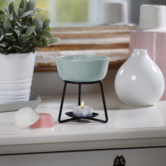 Brucia essenze "Pebble" Yankee Candle con ciotolina e candela accesa sopra